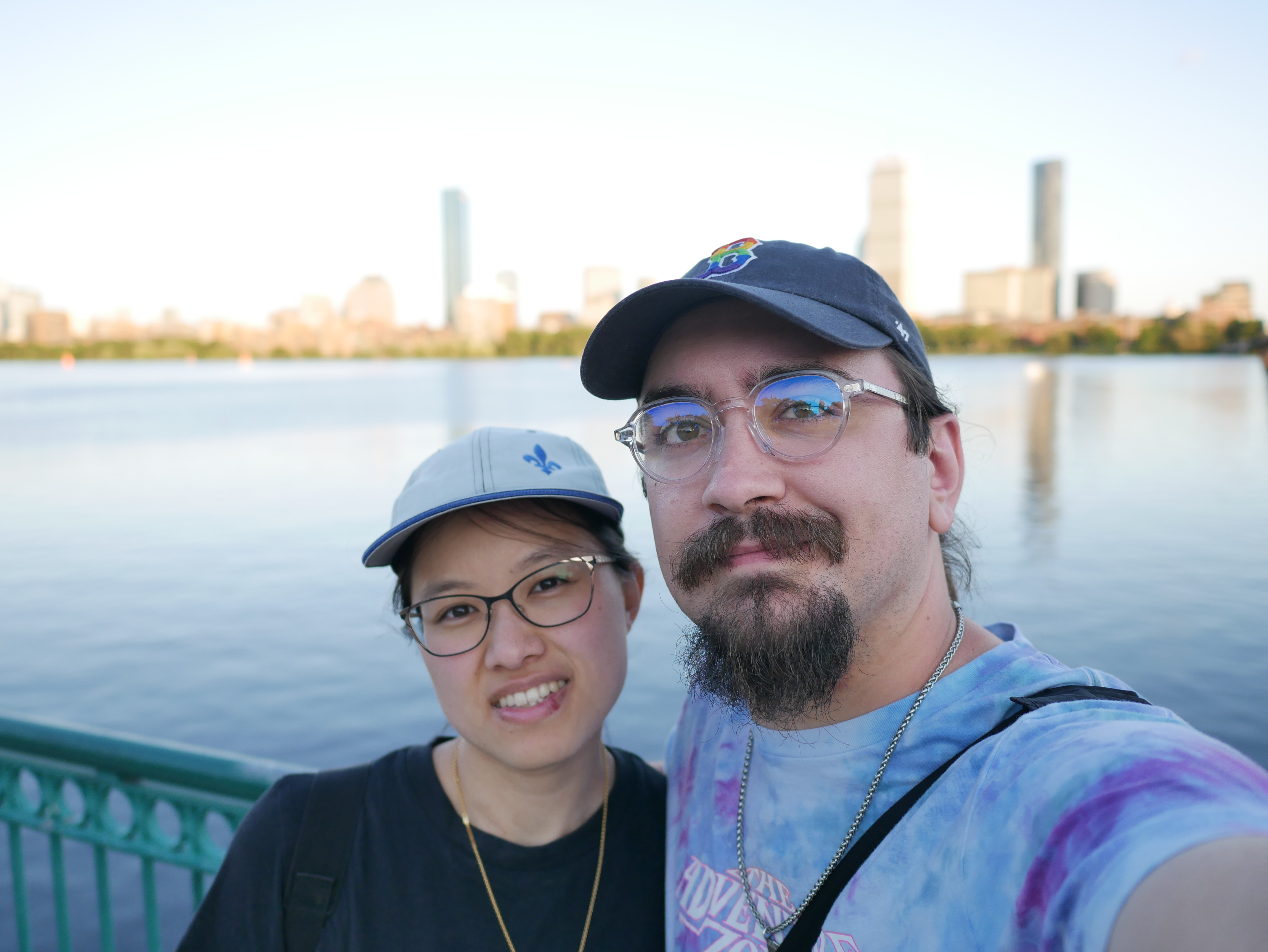 Megan and Andrew next to the Smoots Bridge in Cambridge with the Boston Skyline in the background.